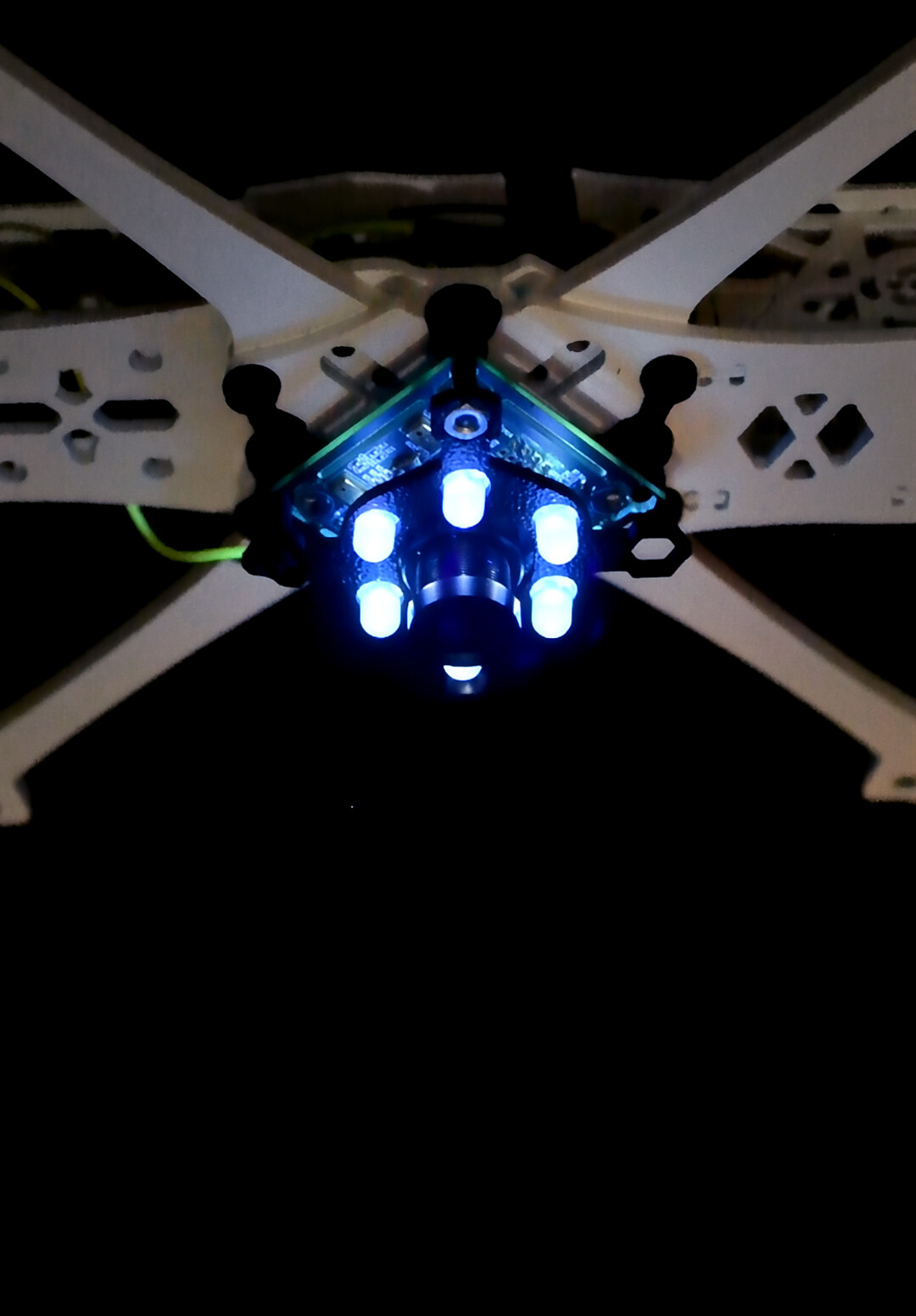 A model of a repurposed FPV drone with a camera and UV lighting attachment.