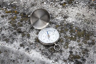 Compass placed on a concrete background
