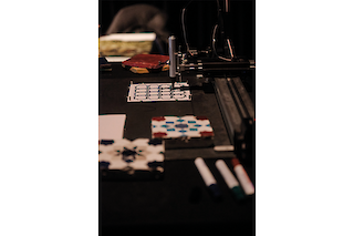 Plotter tracing a Zellij-inspired pattern onto a square piece of paper