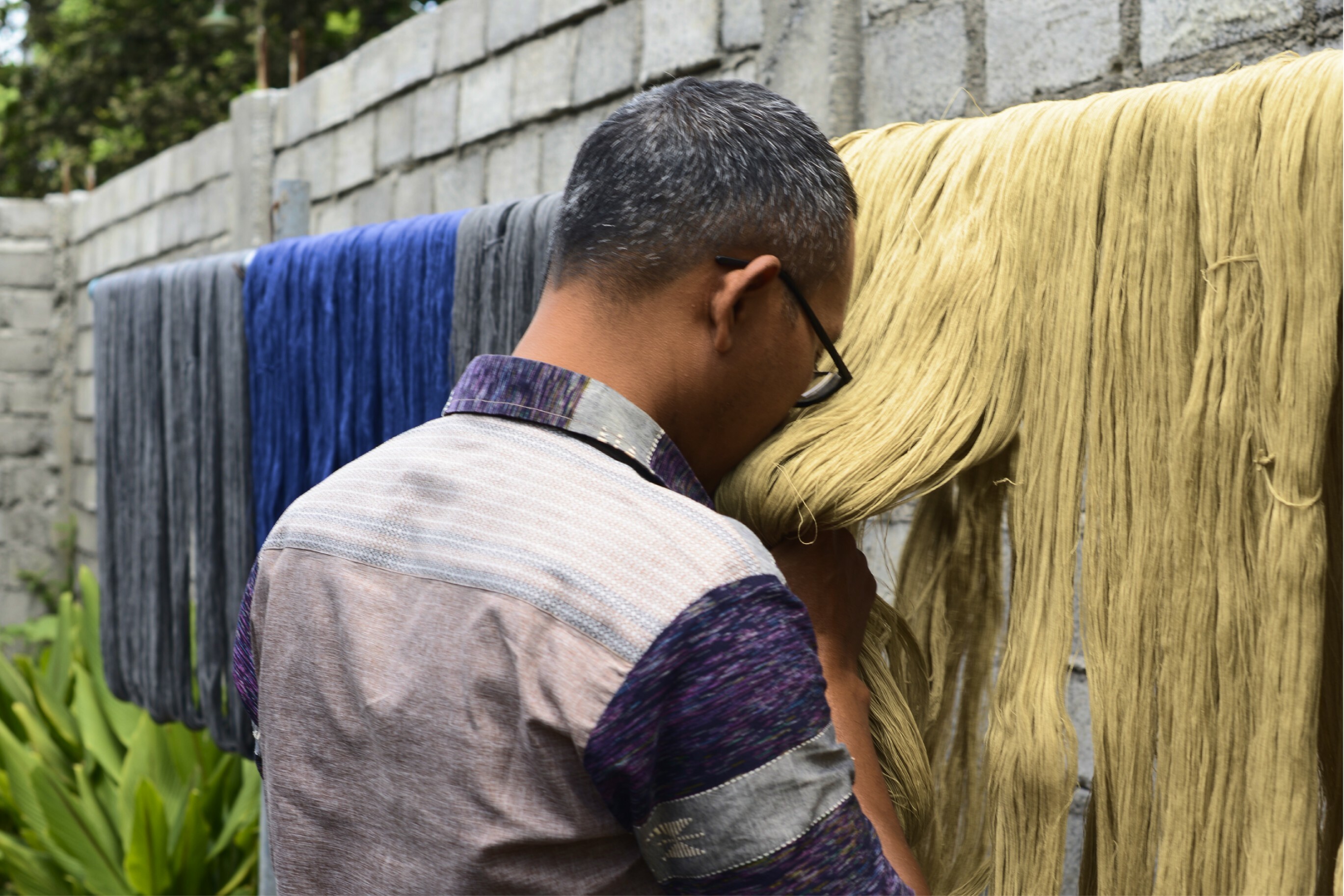 Pak Maliki Smelling the Jackfruit-Dyed Threads, Shafira Nugroho, 2023